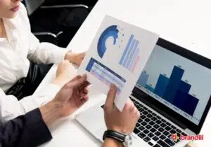 Homem segurando papel com desenhos de gráficos