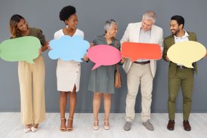 Grupo diversificado segurando balões de fala coloridos